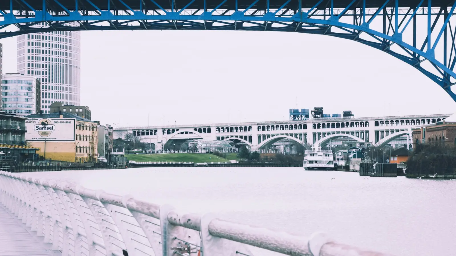 a bridge over a body of water with buildings in the background in bridgeport Connecticut